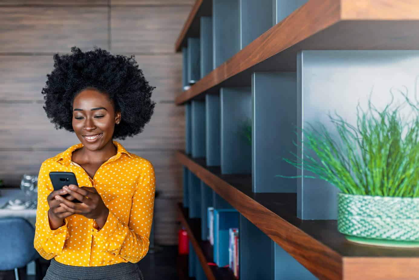 girl smiling looking at her phone