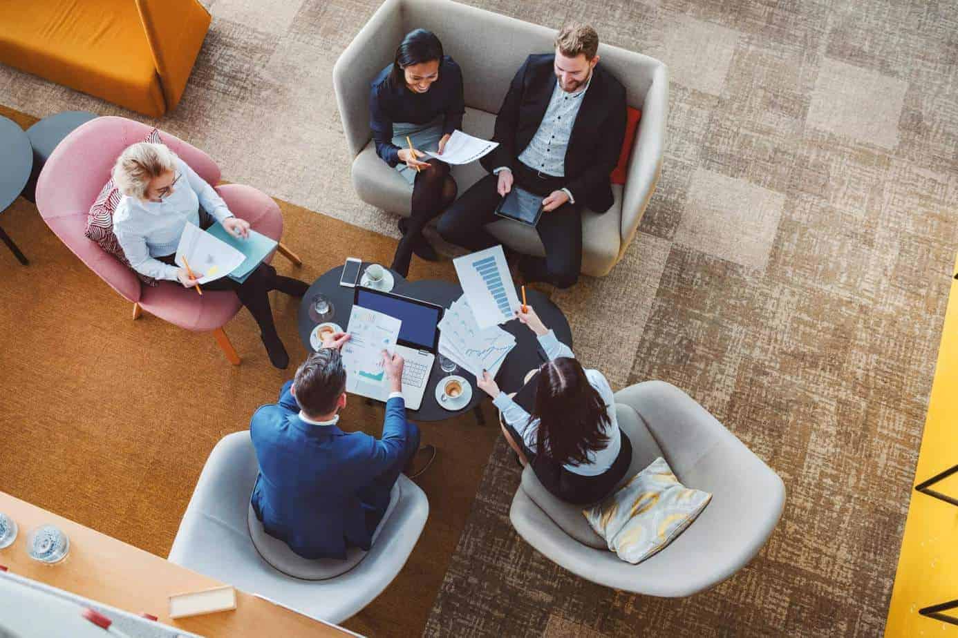 arial view of five people sitting around a round table