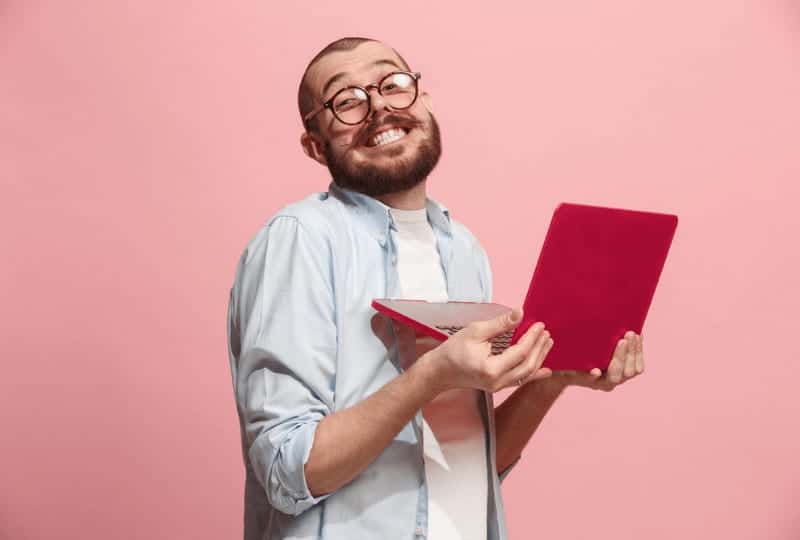 guy really happy holding a lap top