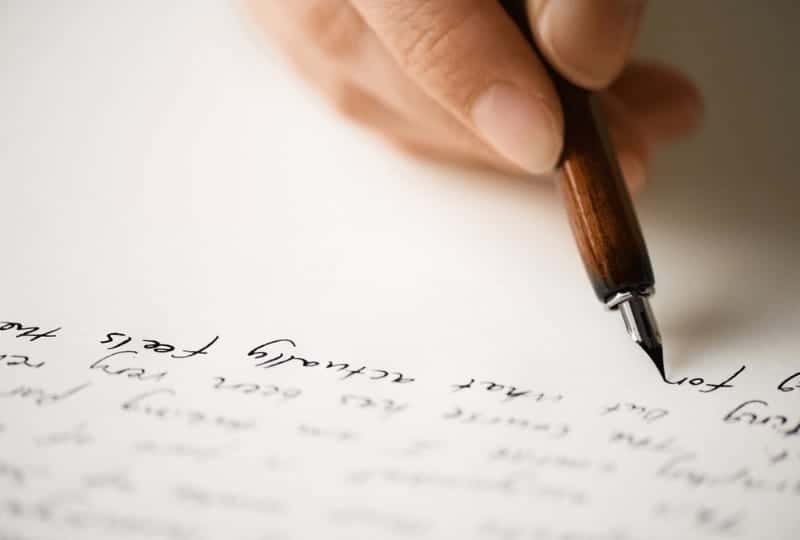 hand writing a letter