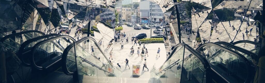 Photo of a shopping center escalator reflected in several mirrors