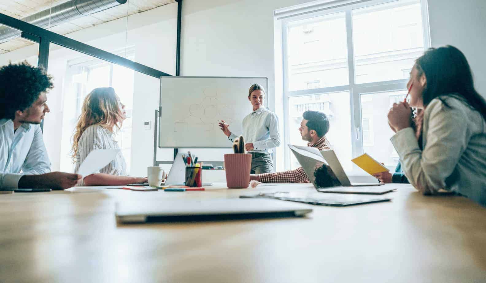 Business meeting in room with whiteboard