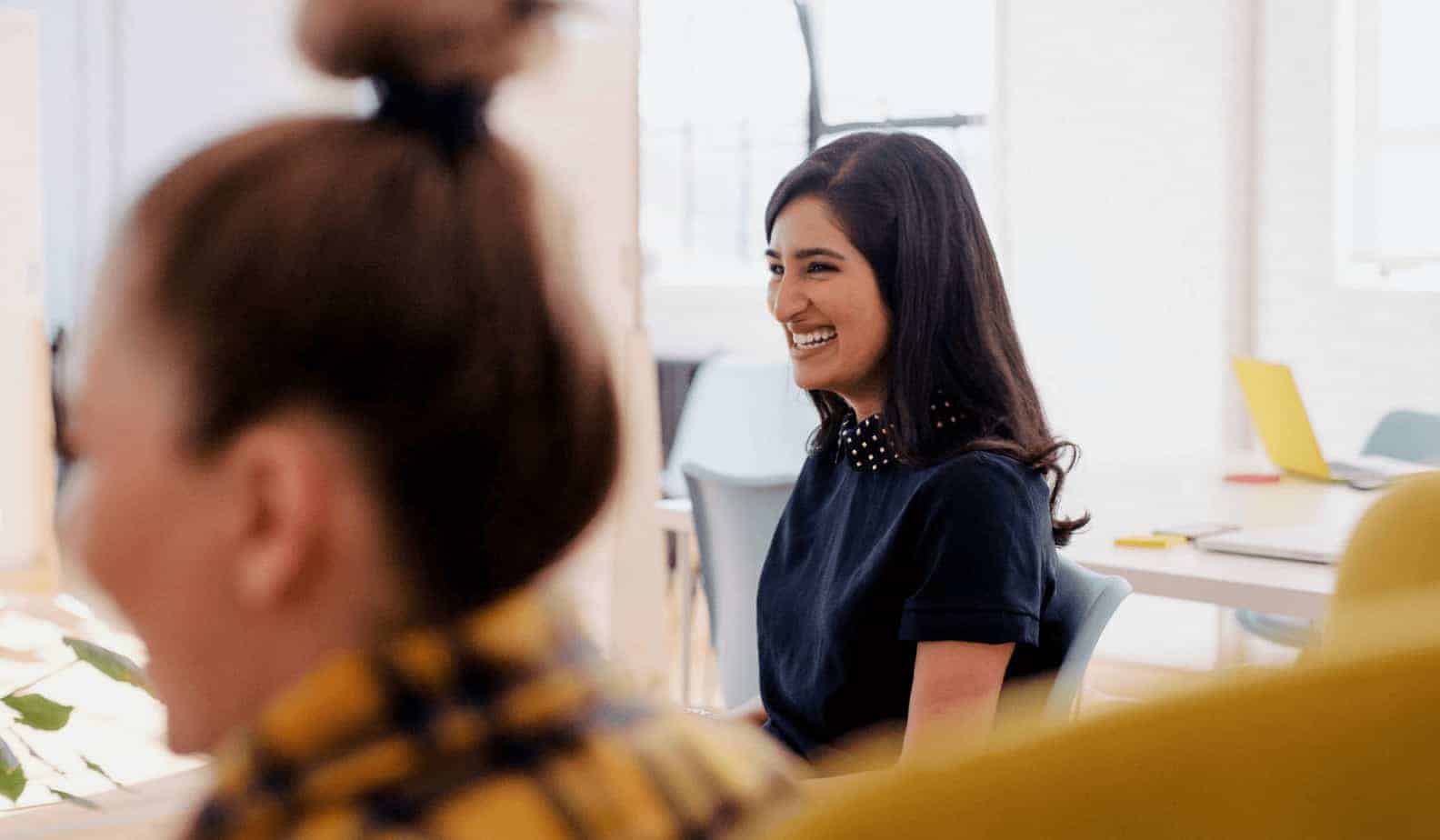 Women smiling in meeting