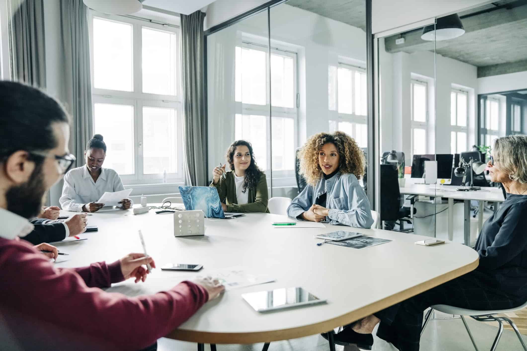 Businesswoman explaining new business strategies to the staff during a meeting in office. Businesswoman giving presentation on a new project to her team.