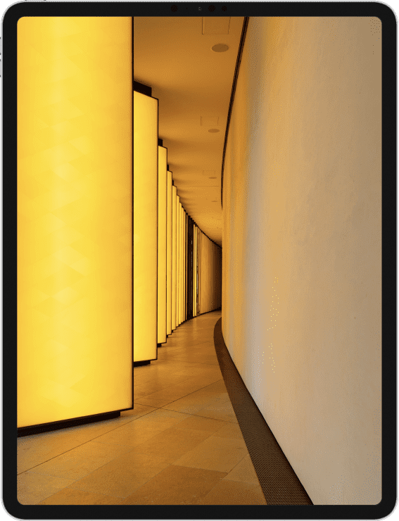 Image of an iPad showing an picture of a hallway bathed in yellow light.