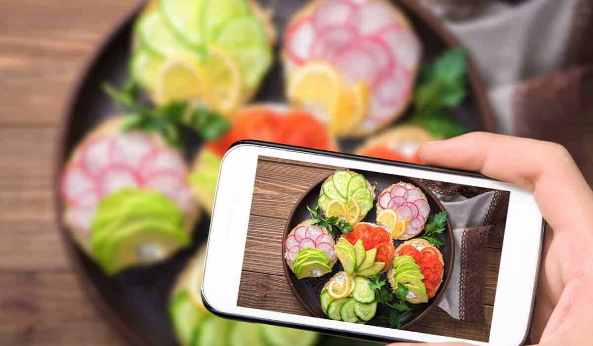 someone taking a photo of a plate of food