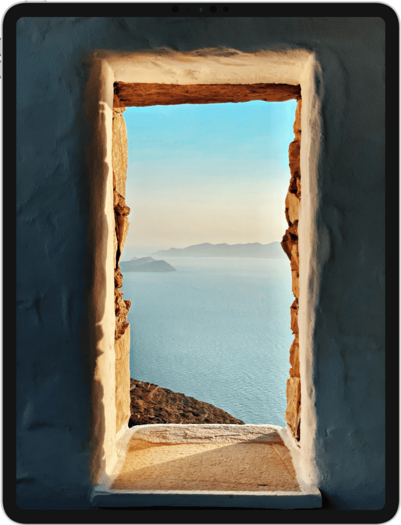 iPad featuring a clay doorway overlooking an oceanside cliff