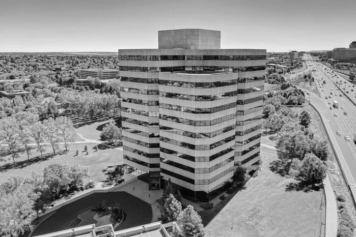 Black and white image of an office building near the highway