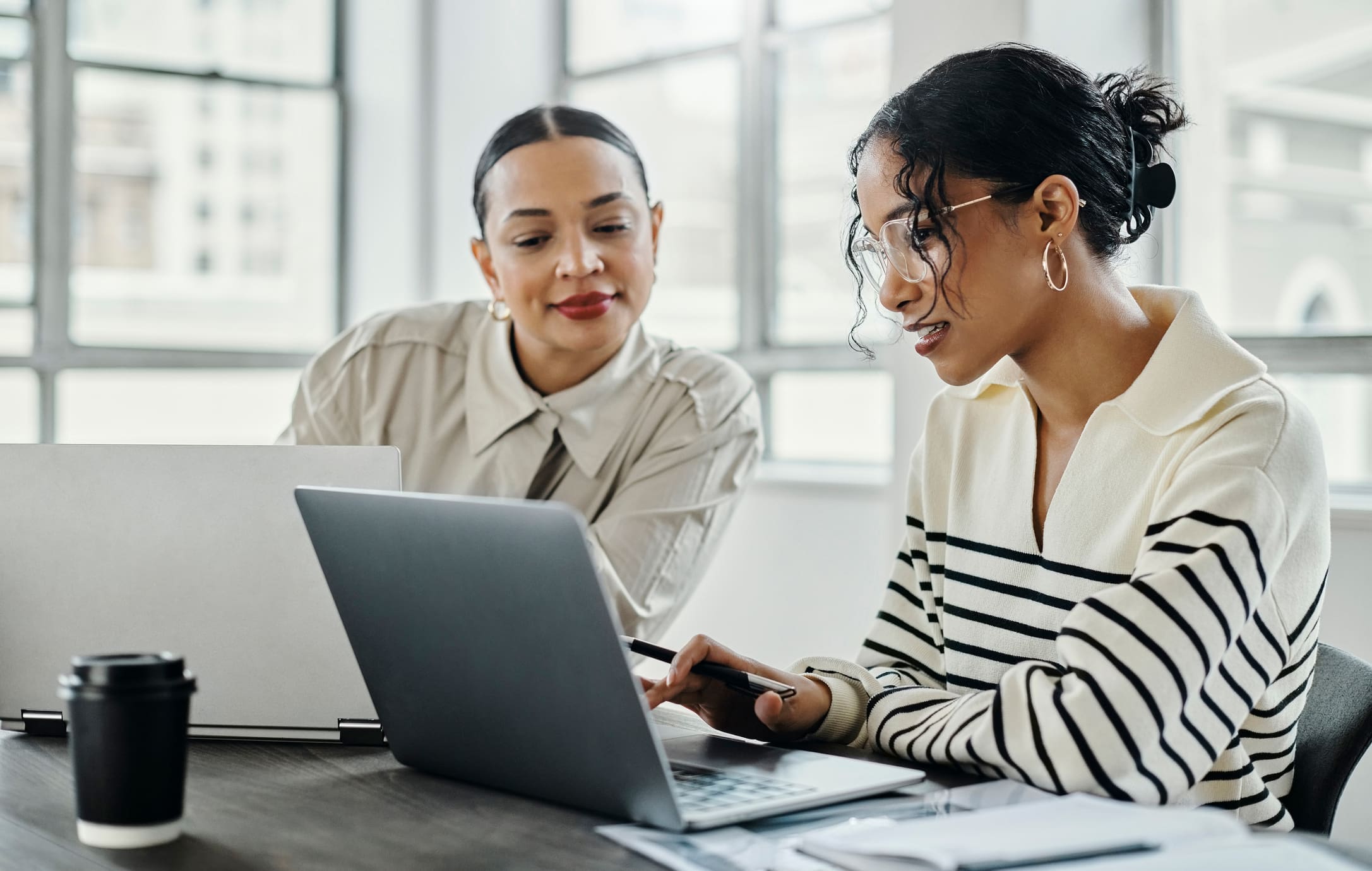 Two women looking at a laptop screen