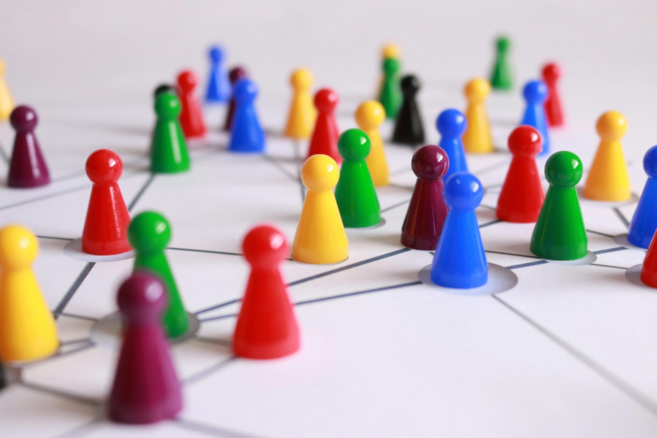 Pieces of a board game connected by lines on a table