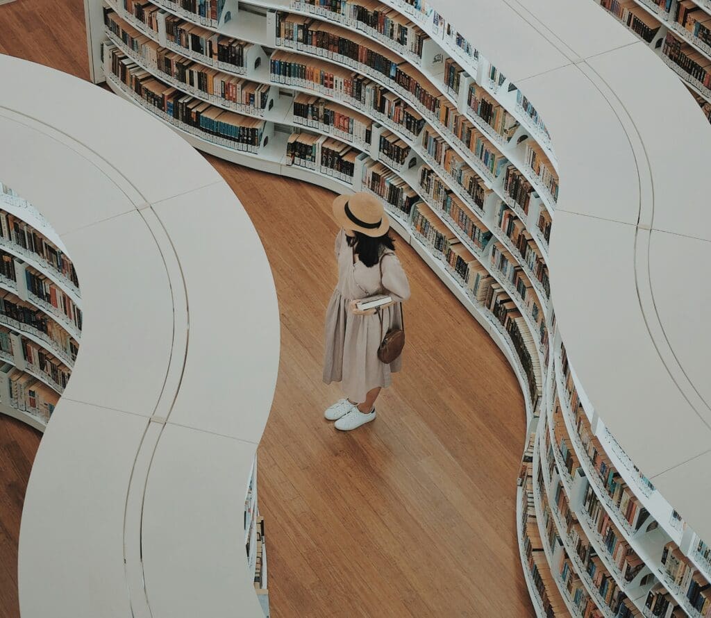 A girl in a library looking at books