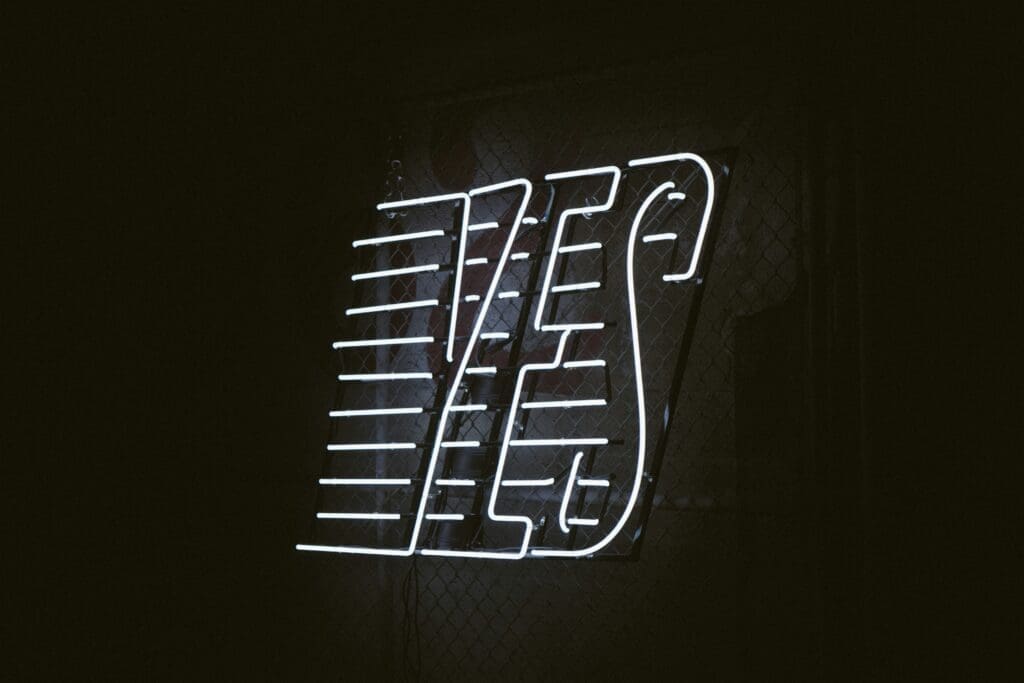 White neon sign that says "YES"